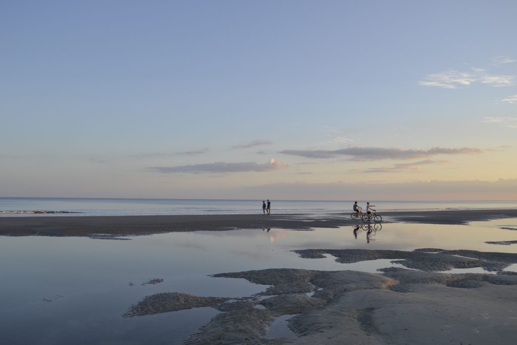 Hilton Head Island, sunset on the beach background people doing sports.